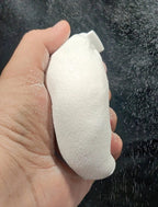 Hand holding a white chalk ball