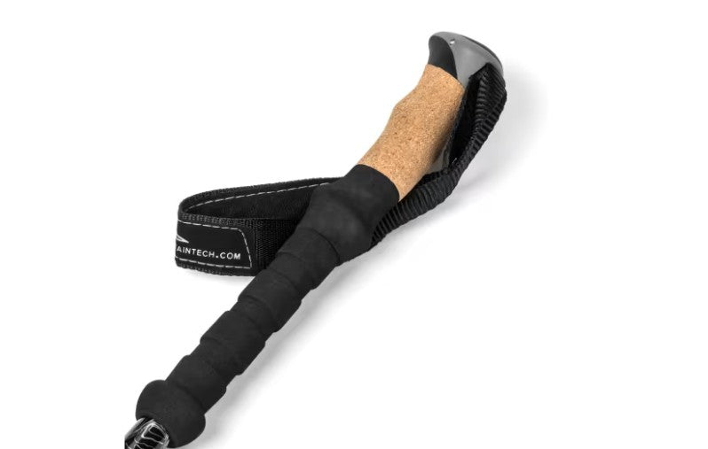 Trekking poles with a black strap and cork handle on a white background