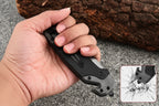 Folding knife with window-breaking feature held in a hand, with text describing its uses.