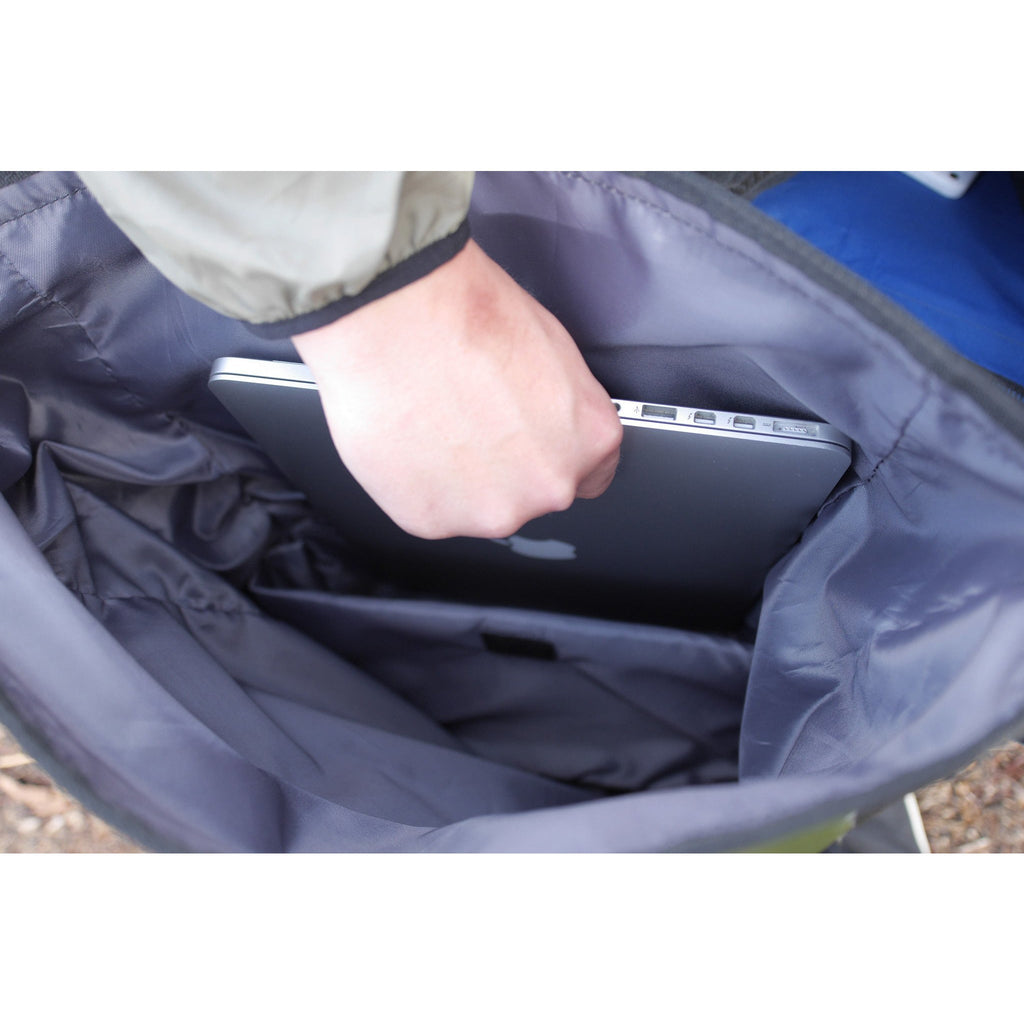 Person placing a laptop into a blue bag