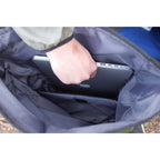 Person placing a laptop into a blue bag