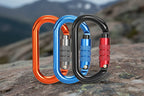 Three colorful carabiners on a white background - offered by the best hiking and climbing gear store in New York, The Adirondack Tool Company.