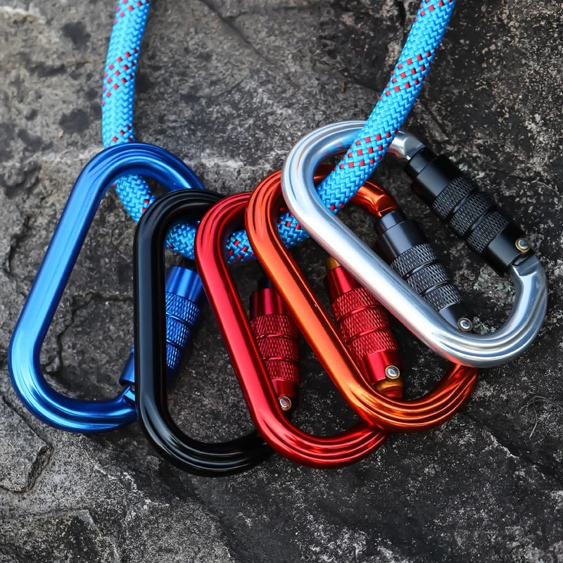 Set of colorful carabiners on a rock surface - offered by the best hiking and climbing gear store in New York, The Adirondack Tool Company