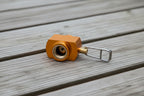 Orange and copper fuel adapter for butane or propane tanks, offered by The Adirondack Tool Co. 