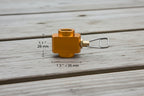 Orange gas tank adapter with measurements and product size label on a white background. Offered by The Adirondack Tool Company