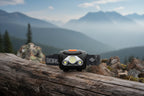 LED headlamp with black strap on a white background