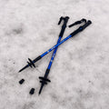 Blue hiking poles on a snowy ground - offered by the premier hiking and climbing gear store in the Northeastern United States, The Adirondack Tool Co.
