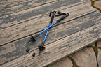 Blue hiking poles on a snowy ground - offered by the premier hiking and climbing gear store in the Northeastern United States, The Adirondack Tool Co.