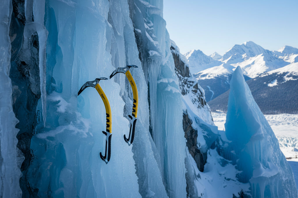 Two black and yellow ice climbing axes offered by The Adirondack Tool Co.