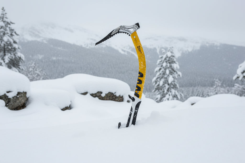 Yellow ice axe with black and silver components on a white background, offered by The Adirondack Tool Co.