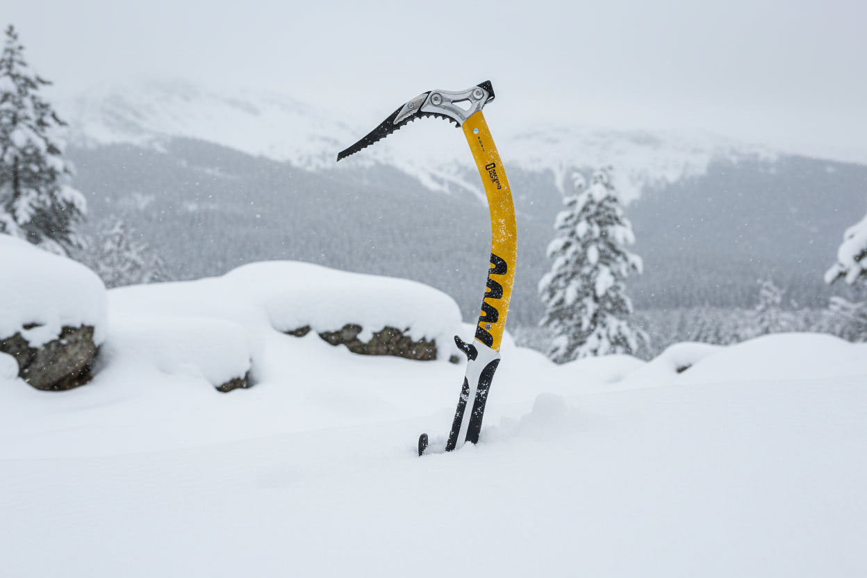 Yellow ice axe with black and silver components on a white background, offered by The Adirondack Tool Co.