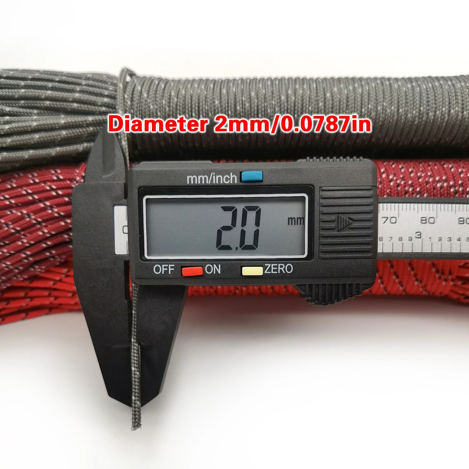 Digital caliper measuring a rope with a diameter of 2mm on a white background