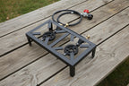 Portable gas stove with two burners and a hose on a white background