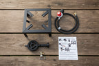 Portable gas stove parts showing burner, valve, hose, and instructions guide. Offered by The Adirondack Tool Co.