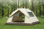 Beige Adirondack Tool Co. pop-up camping tent with four-sided ventilation system on grassy area with trees in the background