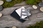 Stainless steel multitool card with various labels on a white background