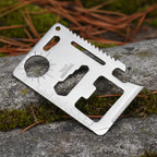 Stainless steel multitool card with various tools on a white background