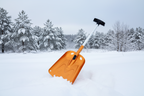 Orange avalanche snow shovel with black handle on an outdoor background - offered by the best mountaineering store in New York, The Adirondack Tool Company.