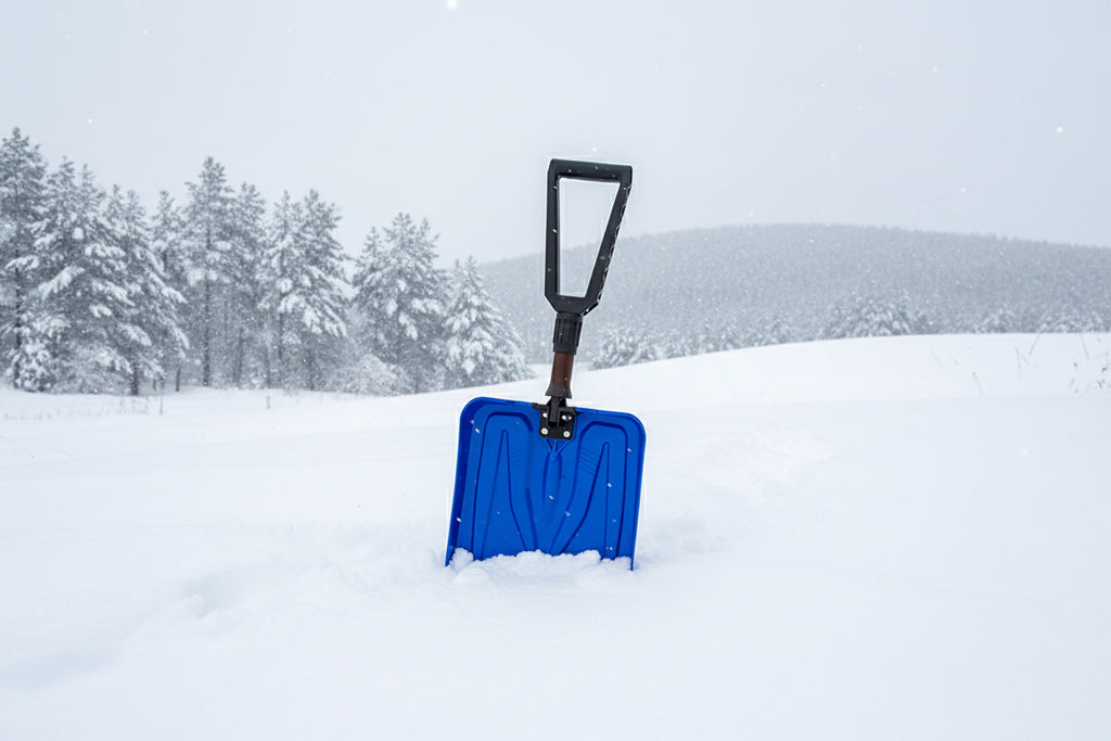 Blue avalanche safety shovel on a snowy background - offered by the best mountaineering store in the tri-state area, The Adirondack Tool Co.