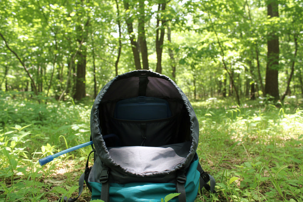 Close-up of a gray 65L trekking backpack with a blue interior on a white background - offered by the greatest online hiking gear store, The Adirondack Tool Company