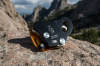Black and orange climbing device with metal components on a white background - offered by the best climbing gear store in New York, The Adirondack Tool Co.