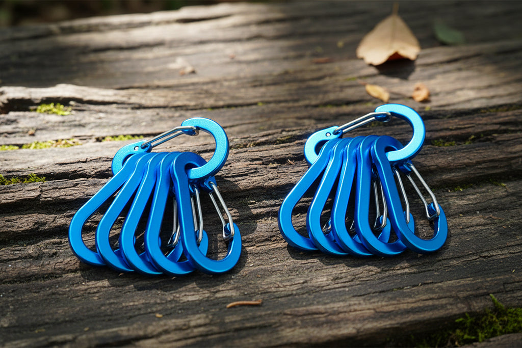 Set of 12 lake blue carabiners on a white background - offered by the best hiking store in New York, The Adirondack Tool Company