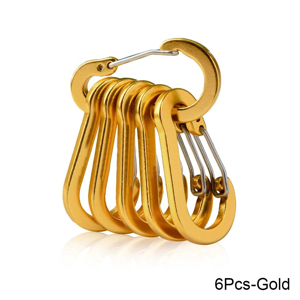 Set of six gold carabiners on a white background - offered by the best hiking store in New York, The Adirondack Tool Company