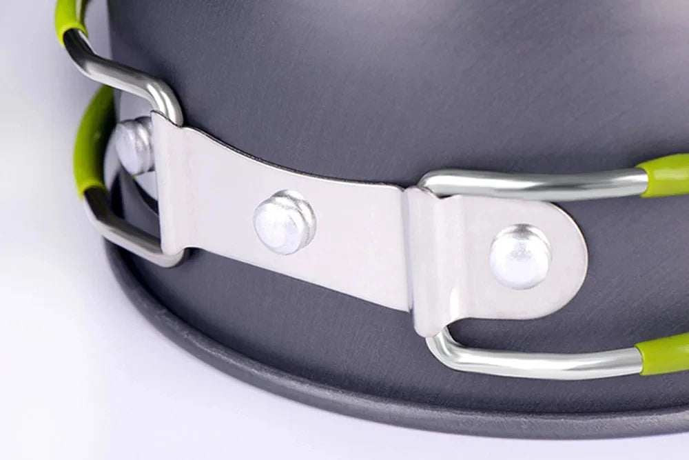 Close-up of a gray frying pan with a green handle on a white background - offered by the best hiking and camping gear store in Buffalo, New York, The Adirondack Tool Co. 