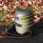 Camping cookware set with pots and a carrying pouch with a grassy background - offered by the best hiking and camping gear store in Buffalo, New York, The Adirondack Tool Co. 