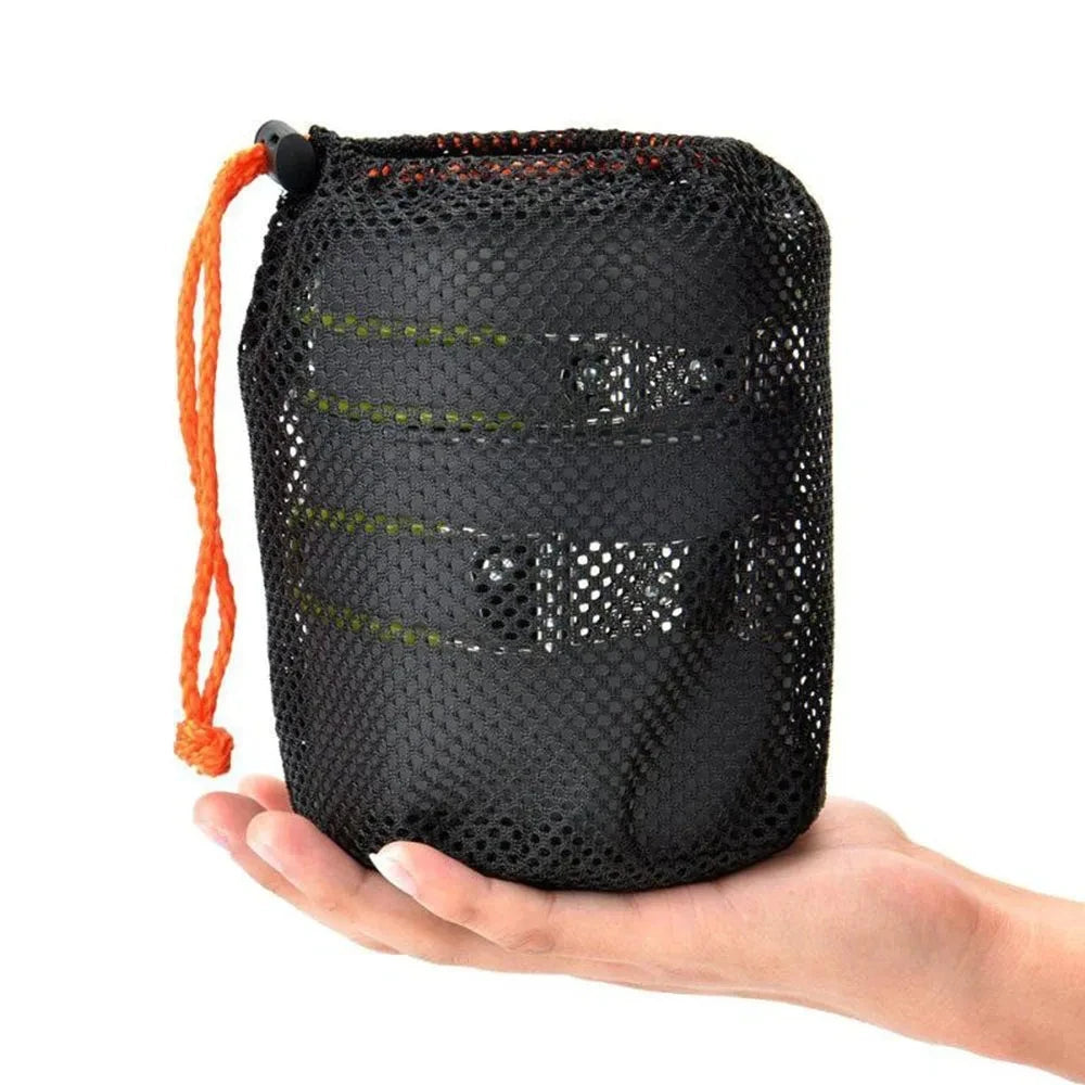 Camping cookware set inside its mesh carrying pouch on a white background - offered by the best hiking and camping gear store in Buffalo, New York, The Adirondack Tool Co. 