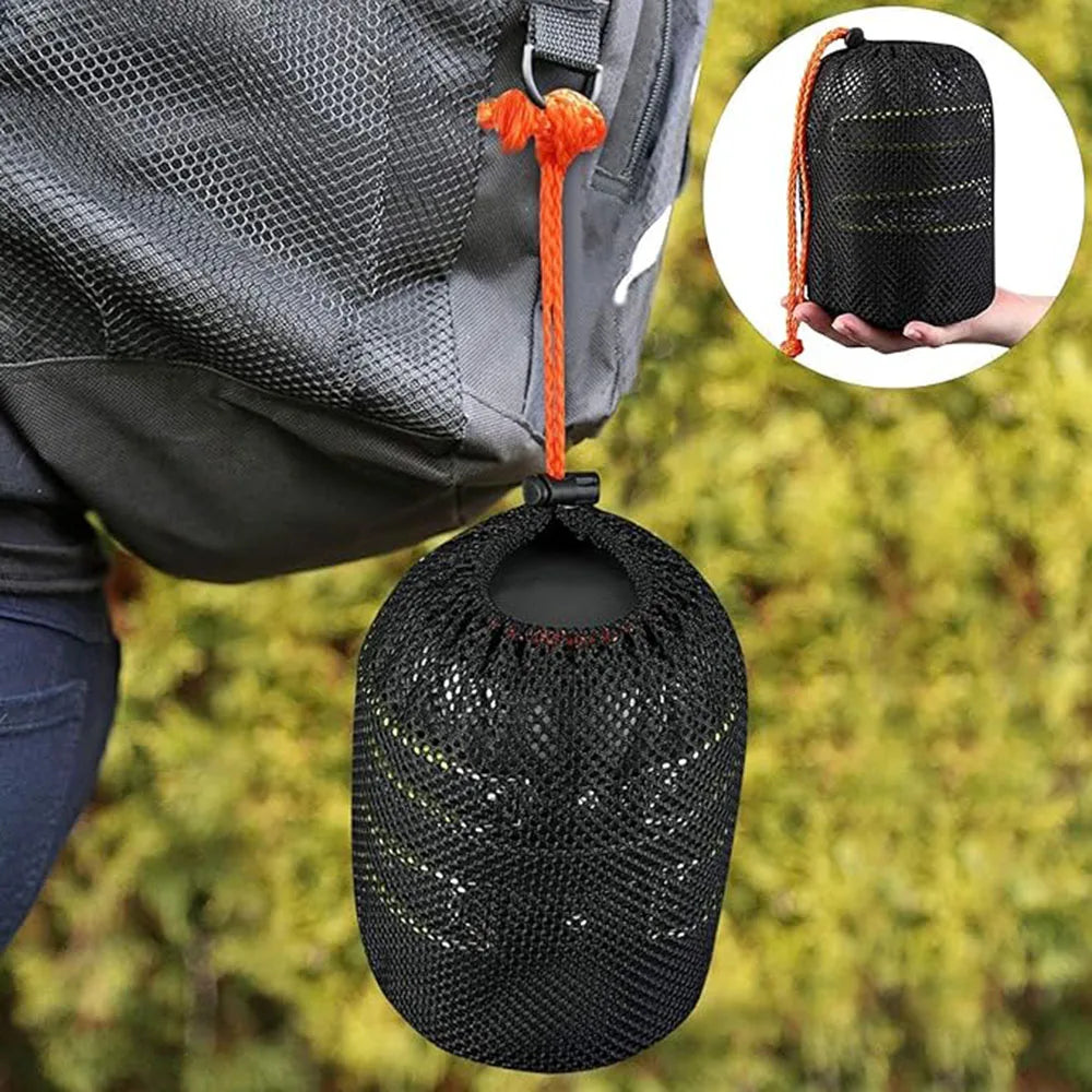 Camping cookware set inside a mesh carrying pouch tied to a backpack on a forest background - offered by the best hiking and camping gear store in Buffalo, New York, The Adirondack Tool Co. 