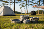 Set of gray camping cookware with carrying bag on an outdoor background - offered by the best camping gear store in New York, The Adirondack Tool Company
