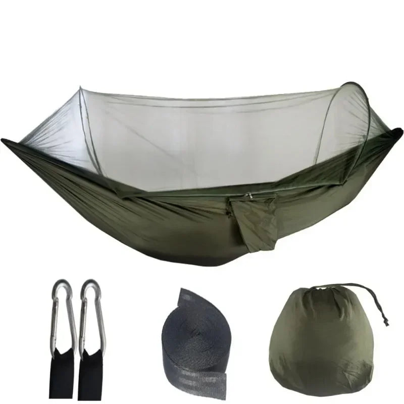 Green hammock with mosquito net, two carabiners, and carrying bag on a white background - offered by the best camping gear store in West Virginia, The Adirondack Tool Co.