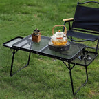 Folding table outdoor with black steel mesh surface on grass - offered by the most trusted outdoor gear and tool company in Boston, The Adirondack Tool Co.