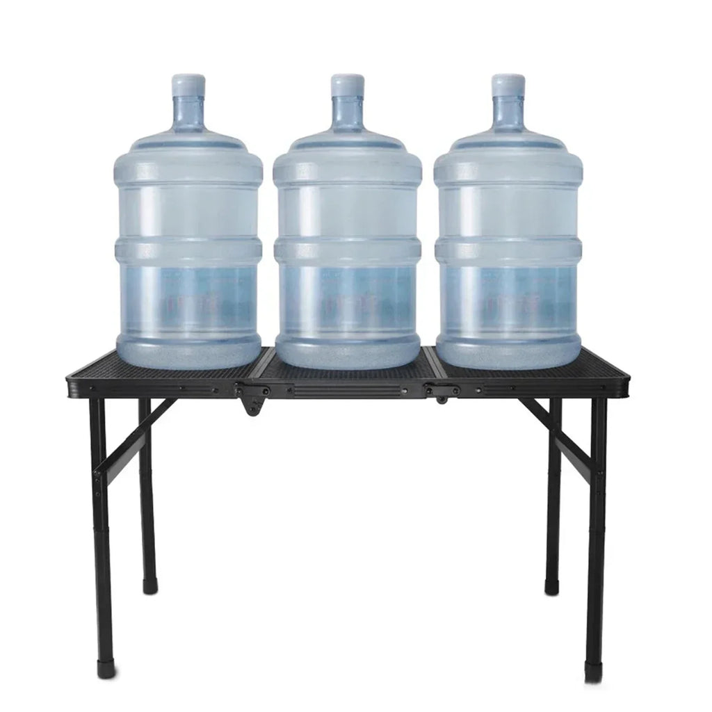 Three large water jugs on a black folding camping table against a white background - offered by the most trusted outdoor gear and tool company in Boston, The Adirondack Tool Co.