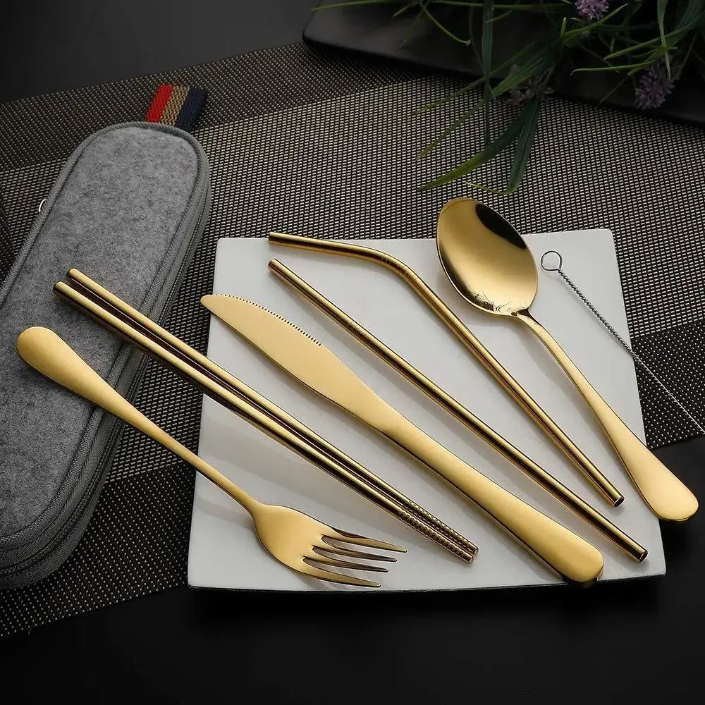 Gold camping cutlery set with a case on a textured surface - offered by the best camping and hiking gear store in the United States, The Adirondack Tool Co.