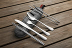 Set of stainless-steel camping cutlery including knife, fork, spoon, and straws in a carrying case on a white background - offered by the best camping and hiking gear store in the United States, The Adirondack Tool Co.