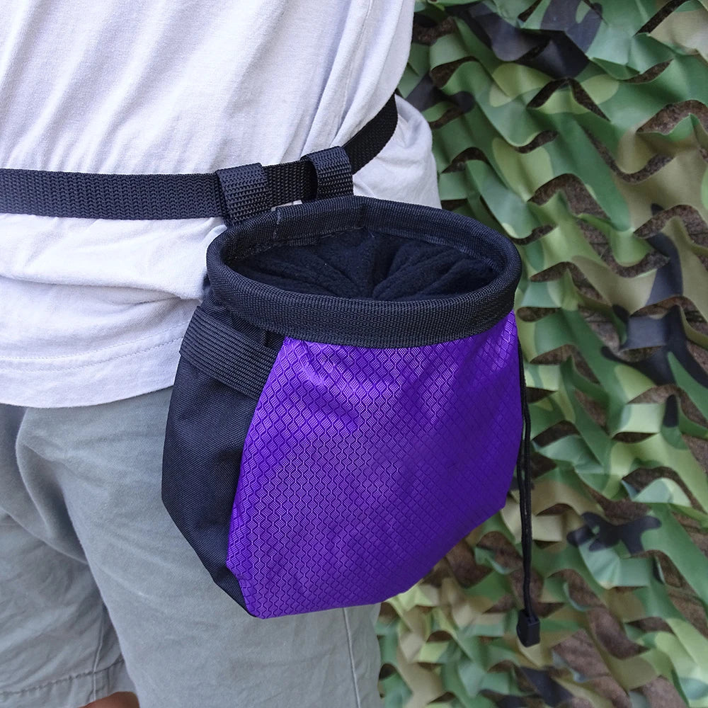 Person wearing a black and purple chalk bag on a camouflage background - offered by the best hiking and climbing gear store in New Hampshire, The Adirondack Tool Co.