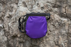 Purple and black chalk bag with a strap on a white background - offered by the best hiking and climbing gear store in New Hampshire, The Adirondack Tool Co.