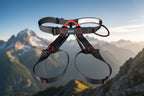 Black climbing harness with red buckles on an outdoor background - offered by the best climbing gear store in America, The Adirondack Tool Co.