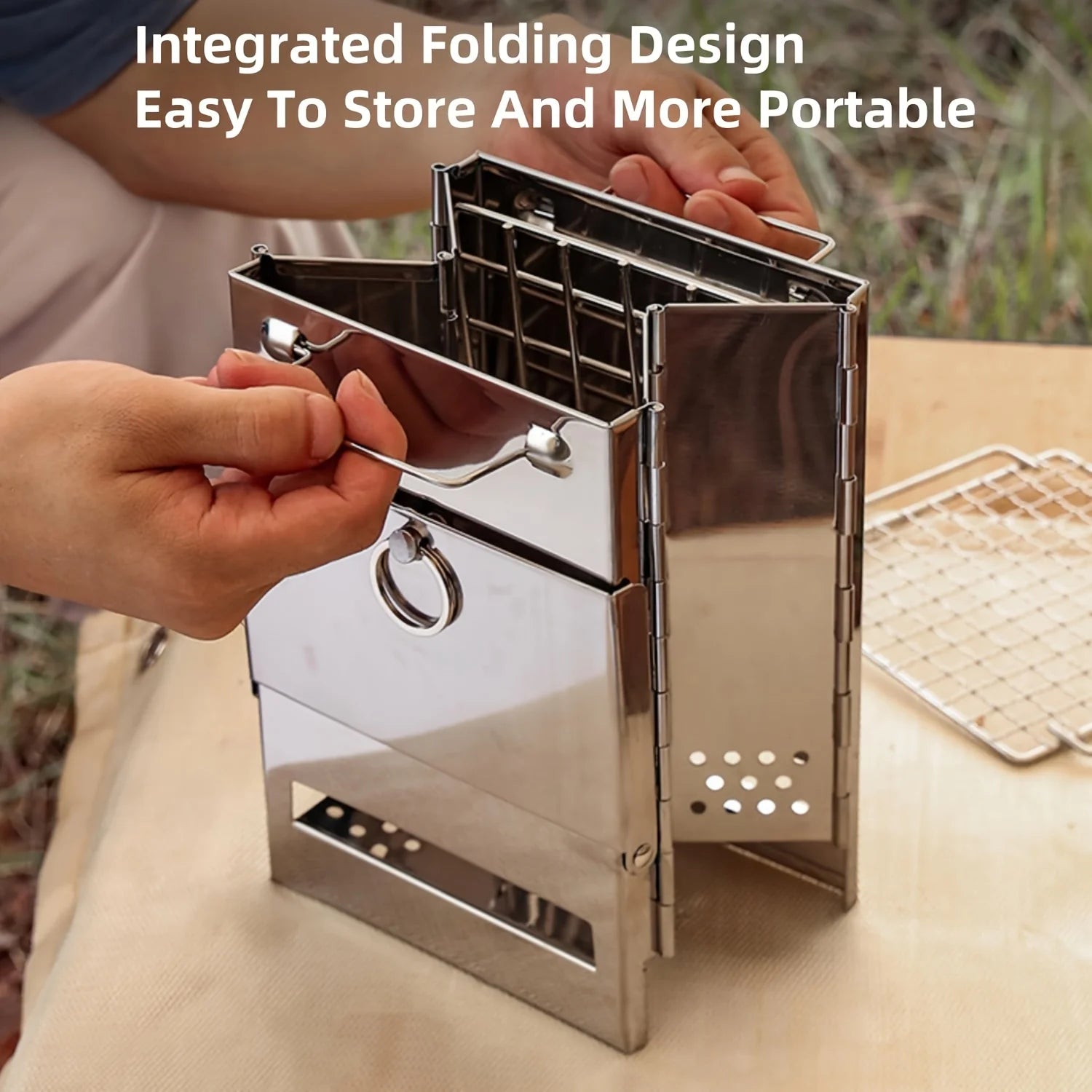 Portable Stainless Steel Wood Stove from The Adirondack Tool Co with text "integrated folding design easy to store and more portable"