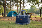 Blue collapsible cooler bag with black mesh and straps on an outdoor background - offered by the best camping, hiking, and climbing gear store in the New England region, The Adirondack Tool Co.