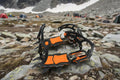 Mountaineering crampons with hikers in the background - offered by the best hiking and camping gear store in Massachusetts, The Adirondack Tool Co.