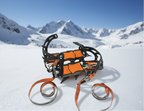 Pair of orange and black crampons with straps on a white background - offered by the best hiking and camping gear store in Massachusetts, The Adirondack Tool Co.