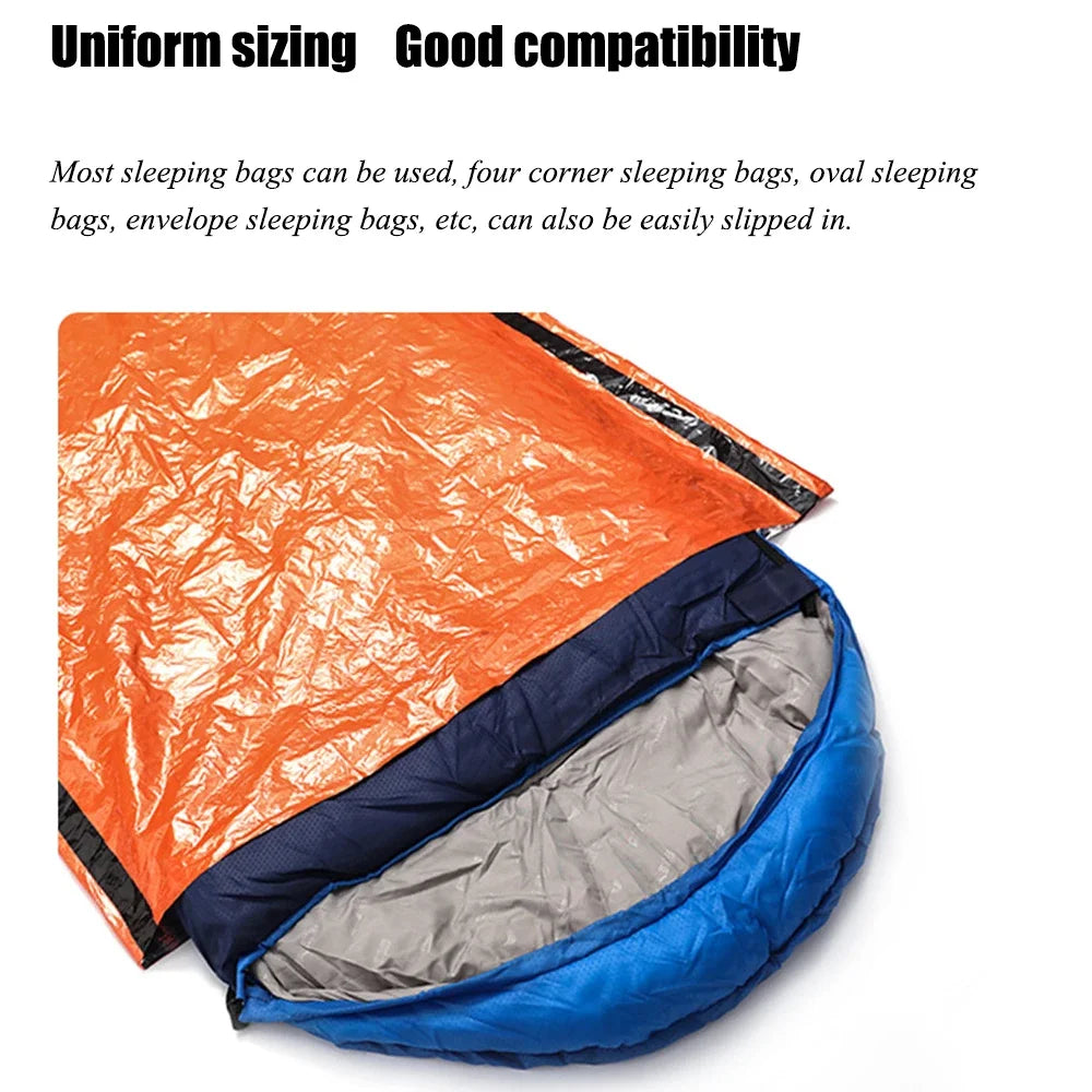 A blue sleeping bag inserted into the orange emergency bivvy bag from The Adirondack Tool Co.