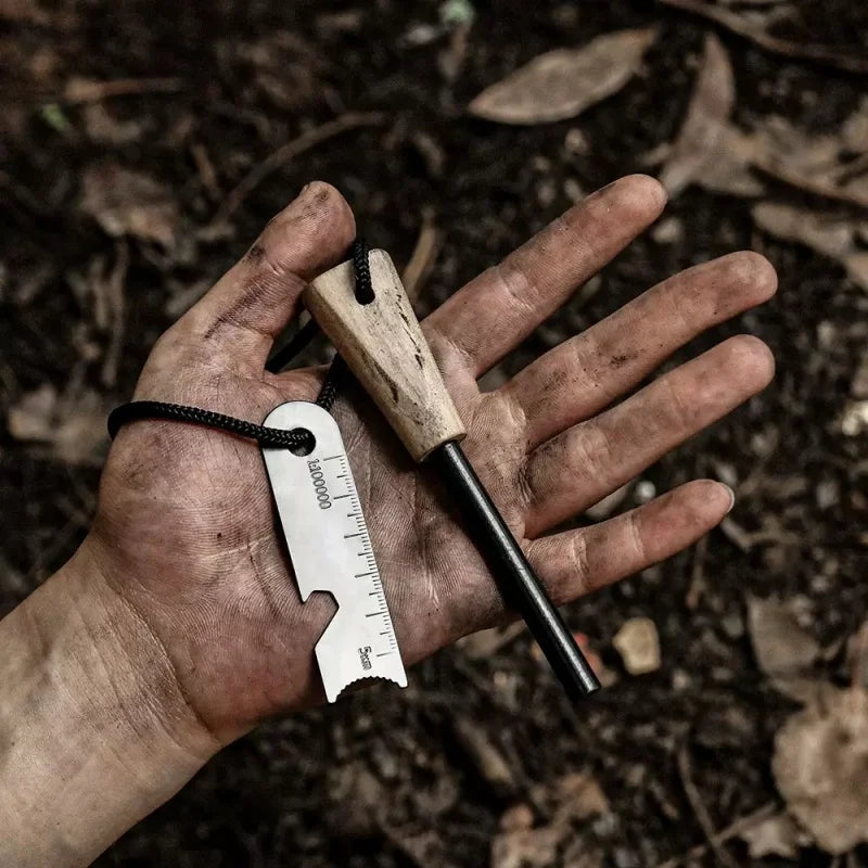 Hand holding a multi-tool with a fire starter against a natural background - offered by the best camping gear store in New York, The Adirondack Tool Co.