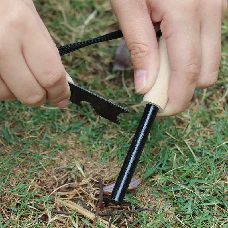 Person using a firestarter on grass - offered by the best camping gear store in New York, The Adirondack Tool Co.