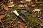 Firestarter multitool with magnesium strip with wooden handle and steel striker stick on a white background - offered by the best camping gear store in New York, The Adirondack Tool Co.