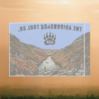 Flag of a mountain landscape with a river and 'The Adirondack Tool Co.' logo on an orange background