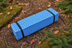 Blue foam sleeping / sitting mat from The Adirondack Tool Co. folded and packed.